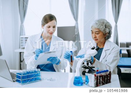 Scientist team meeting and writing analysis results in the laboratory study and analyze scientific sample for global warming, analytics and tech.. 105461986