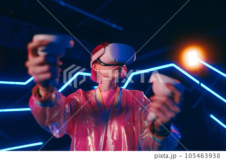 A young woman plays virtual games. Neon room for vr games. 105463938