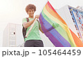 Smiling handsome young man with LGBT flag in his hands 105464459