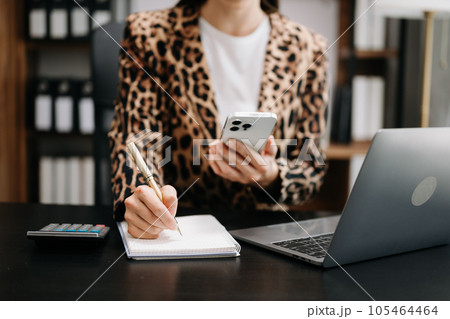 businesswoman hand working with new modern computer and writing on the notepad strategy diagram as concept 105464464