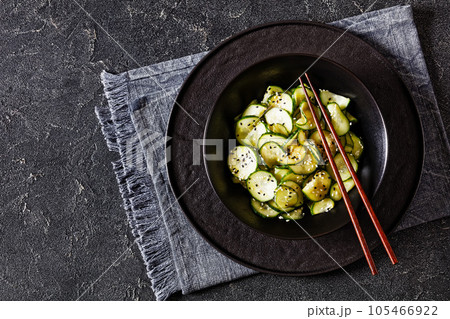 Sunomono, Japanese Cucumber Salad in a black bowl 105466922