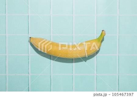 Condoms on bananas on a blue background Condoms on bananas on a blue background 105467397