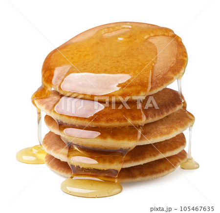 Pancakes poured with honey on a white background. Isolated 105467635