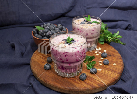 Homemade blueberry smoothie with mint on a blue fabric background. Detox diet 105467647