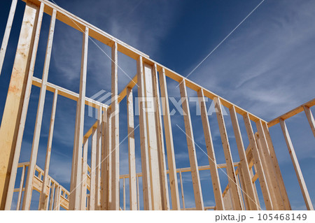 Construction frame house of wooden beam stick framework on new build home Construction frame house of wooden beam stick framework on new build home 105468149