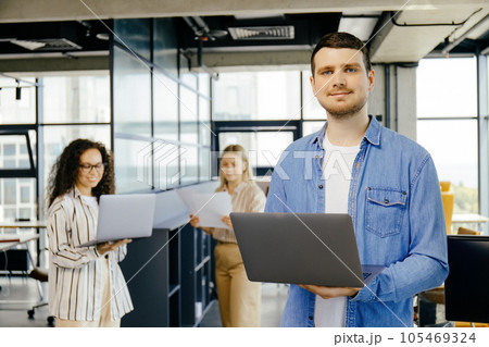 A guy with a laptop in his hands in the office 105469324