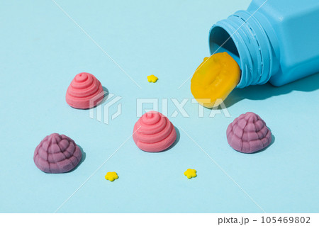 Jelly candies and blue jar on blue background Jelly candies and blue jar on blue background 105469802