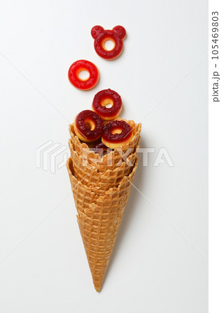 Jelly candies in waffles cones on white background, top view 105469803