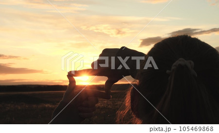 sign photo video frame, girl shows hands fingers sunset frame, family dream happiness journey, amazing beautiful sunset, girl park making hand gesture frame by sunset summer, vision strategy concept sign photo video frame, girl shows hands fingers sunset frame, family dream happiness journey, amazing beautiful sunset, girl park making hand gesture frame by sunset summer, vision strategy concept 105469868