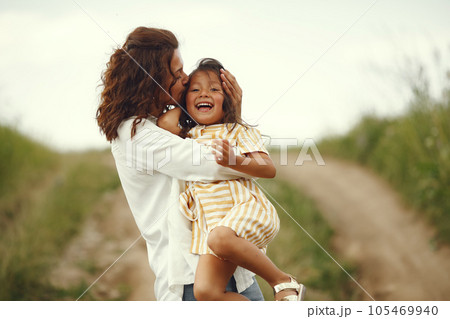 Family in a summer field. Sensual photo. Cute little girl. Family in a summer field. Sensual photo. Cute little girl. 105469940