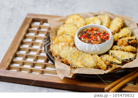fried eggplant, Flatten the eggplant and dredge in the tempura flour, shaking off any excess. Mix the tempura flour, egg, and water to make a tempura batter. Once the oil is hot, coat the trimmed eggp fried eggplant, Flatten the eggplant and dredge in the tempura flour, shaking off any excess. Mix the tempura flour, egg, and water to make a tempura batter. Once the oil is hot, coat the trimmed eggp 105470632
