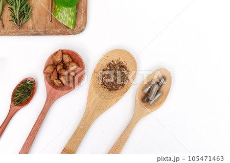 Top view of Herbal medicine preparation with fresh herbs and dried flowers, aromatherapy essential oil and mortar with pestle used in natural alternative remedies on white table. Top view of Herbal medicine preparation with fresh herbs and dried flowers, aromatherapy essential oil and mortar with pestle used in natural alternative remedies on white table. 105471463