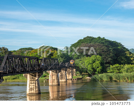 The train is passing through the Death Railway Bridge over the River Kwai in Kanchanaburi.  During World War Two Japan constructed railway from Thailand to Burma This is now know the Death Railway. 105473775