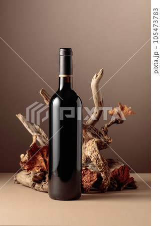 Bottle of red wine with a composition of old wood. Bottle of red wine with a composition of old wood. 105473783