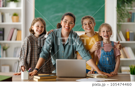 Happy kids and teacher at school Happy kids and teacher at school 105474460