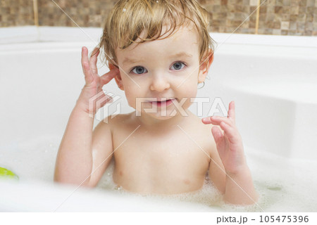 Funny little boy getting a bath in the bathroom. Funny little boy getting a bath in the bathroom. 105475396
