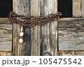 Close-up of old wooden gates with a chain lock. 105475542