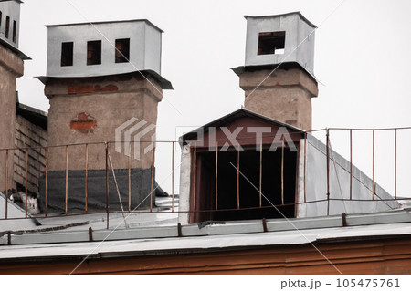 Metal roof with railings, chimneys and attic window 105475761
