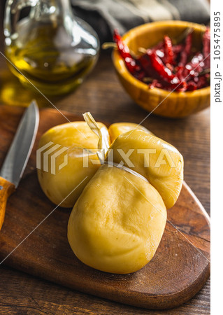 Smoked scamorza cheese on cutting board. 105475895