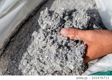 Cellulose insulation for walls and floors In hand. Recycled newsprint. Heat preservation and energy 105476711