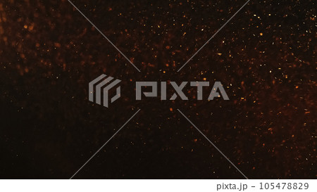 Sparks texture. Fire ash. Grain overlay. Blur orange red color burning dust particles flying on dark black copy space abstract background. 105478829