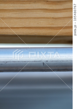 close up of metal pipe tube and wood background close up of metal pipe tube and wood background 105480767