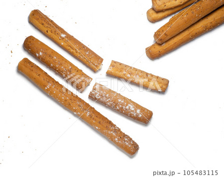 Sesame biscuits on a white background. Biscuits are elongated in the form of sticks. Bread products. Flour products. Healthy food. Sesame biscuits on a white background. Biscuits are elongated in the form of sticks. Bread products. Flour products. Healthy food. 105483115
