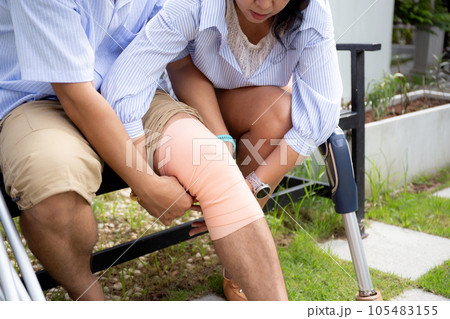 Closeup hands young asian couple disabled take care while woman applying bandage with man. Closeup hands young asian couple disabled take care while woman applying bandage with man. 105483155