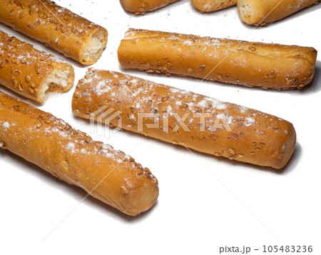 Sesame biscuits on a white background. Biscuits are elongated in the form of sticks. Sesame biscuits on a white background. Biscuits are elongated in the form of sticks. 105483236