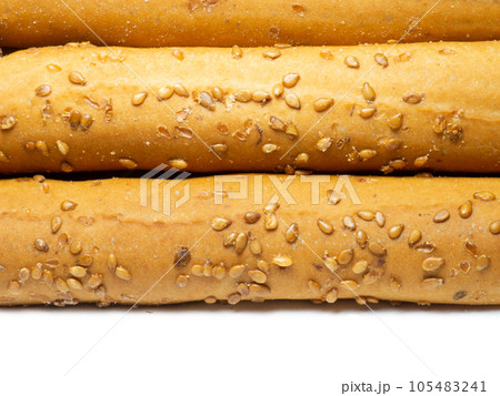 Sesame biscuits on a white background. Biscuits are elongated in the form of sticks. Sesame biscuits on a white background. Biscuits are elongated in the form of sticks. 105483241
