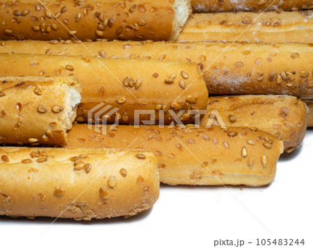 Sesame biscuits on a white background. Biscuits are elongated in the form of sticks. Sesame biscuits on a white background. Biscuits are elongated in the form of sticks. 105483244