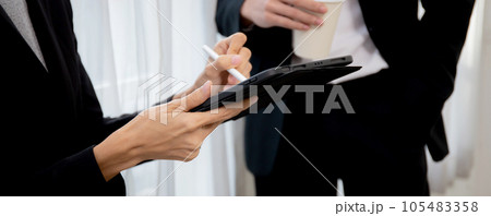 Closeup hands of business team man and woman talking about marketing on digital tablet. 105483358