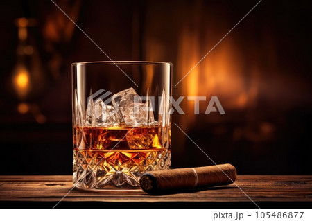 Whiskey glass and cigar on wooden table 105486877
