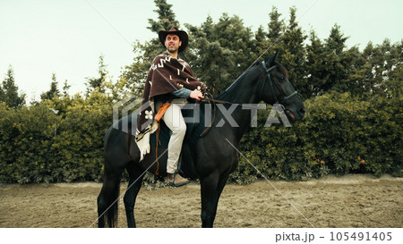 In the ranch cowboy and black horse 105491405