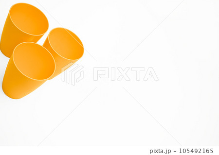 Orange plastic cups for camping, travel isolated on white Orange plastic cups for camping, travel isolated on white 105492165
