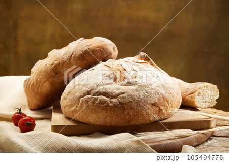Composition with whole grain bread with fresh tomatoes on rustic wooden board closeup. Composition with whole grain bread with fresh tomatoes on rustic wooden board closeup. 105494776