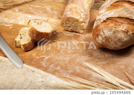 Freshly baked crispy and toasted ciabatta bread sliced on wooden cutting board. 105494866
