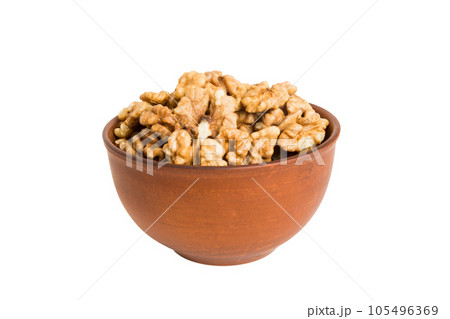 Roasted walnuts in bowl isolated on white background. walnuts is snack or raw of cook. Healthy food concept Roasted walnuts in bowl isolated on white background. walnuts is snack or raw of cook. Healthy food concept 105496369