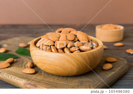 Fresh healthy Almond in bowl on colored table background. Top view Fresh healthy Almond in bowl on colored table background. Top view 105496380