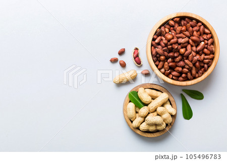 Fresh healthy peanuts in bowl on colored table background. Top view Healthy eating bertholletia concept. Super foods Fresh healthy peanuts in bowl on colored table background. Top view Healthy eating bertholletia concept. Super foods 105496783