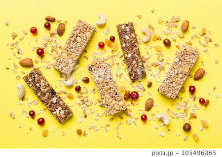 Various granola bars on table background. Cereal granola bars. Superfood breakfast bars with oats, nuts and berries, close up. Superfood concept 105496865