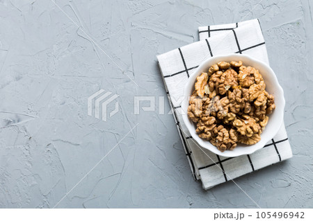Fresh healthy walnuts in bowl on colored table background. Top view Healthy eating bertholletia concept. Super foods 105496942