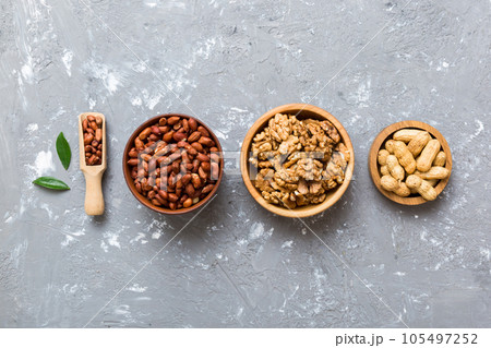 Walnut kernel halves, in a wooden bowl. Close-up, from above on colored background. Healthy eating Walnut concept. Super foods with copy space Walnut kernel halves, in a wooden bowl. Close-up, from above on colored background. Healthy eating Walnut concept. Super foods with copy space 105497252