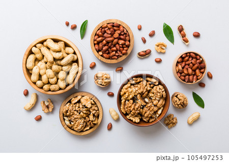 Walnut kernel halves, in a wooden bowl. Close-up, from above on colored background. Healthy eating Walnut concept. Super foods with copy space 105497253