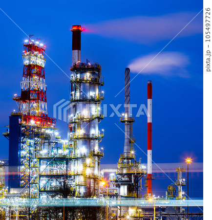 Oil refinery at dusk. Communications in a refinery - refinery equipment and machines. Oil refinery at dusk. Communications in a refinery - refinery equipment and machines. 105497726