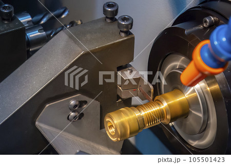 Close up scene the CNC lathe machine thread cutting at the end of brass pipe coupling parts. 105501423
