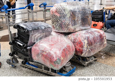 Multiple luggages wrapped with protective film for protection and security during transportation in air travel. 105501953