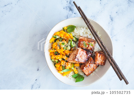 Teriyaki salmon with rice and mango in white bowl. Asian cuisine concept. 105502735