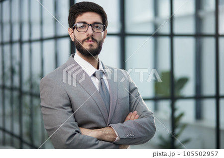 Portrait of serious handsome successful businessman in glasses and suit. 105502957