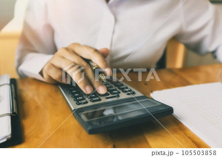 Business woman accountant or banker using calculator in office. Savings, finances and economy concept. 105503858